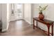 Inviting foyer with wood-look flooring, stylish console table, and decorative glass front door at 4086 E Narrowleaf Dr, Gilbert, AZ 85298