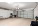 Spacious garage with epoxy floor, built-in cabinets, and room for multiple vehicles at 4086 E Narrowleaf Dr, Gilbert, AZ 85298