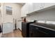 Convenient laundry room with modern appliances, white cabinets, and ample counter space at 4086 E Narrowleaf Dr, Gilbert, AZ 85298
