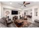 Inviting living room with a ceiling fan, recessed lighting, and comfortable leather seating at 4086 E Narrowleaf Dr, Gilbert, AZ 85298