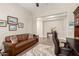 Relaxing office area with a leather sofa, desk, stylish rug, and natural lighting at 4086 E Narrowleaf Dr, Gilbert, AZ 85298