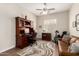 Inviting office with a wooden desk, comfortable seating, exercise bike, and natural light at 4086 E Narrowleaf Dr, Gilbert, AZ 85298