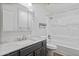 Bathroom features modern vanity, marble countertops, shower and tub combo, and bright lighting at 445 S Omaha --, Mesa, AZ 85206