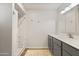 Bathroom features modern vanity, marble countertops, walk-in shower with marble surround, and bright lighting at 445 S Omaha --, Mesa, AZ 85206