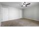 Bedroom features neutral carpet, ceiling fan, and white walls with white doors and trim at 445 S Omaha --, Mesa, AZ 85206