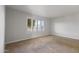 Serene bedroom with neutral carpet, plantation shutters, and views of the surrounding neighborhood at 445 S Omaha --, Mesa, AZ 85206