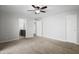 Bedroom features neutral carpet, ceiling fan, and walk-in closet; bathroom is visible in background at 445 S Omaha --, Mesa, AZ 85206