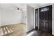 Clean, bright view into the home, showing the entry and connecting living spaces with wood-look floors and new paint at 445 S Omaha --, Mesa, AZ 85206