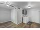 Bright laundry room with a ceiling fan, wooden floors, washer, dryer, cabinets, and a laundry-themed rug at 445 S Omaha --, Mesa, AZ 85206