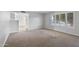 Bright living room featuring a large window with shutters and neutral carpeting at 445 S Omaha --, Mesa, AZ 85206