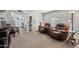 Spacious living room with comfortable recliners and sofa, set on neutral carpeting, with a view to the dining area at 445 S Omaha --, Mesa, AZ 85206