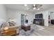 Cozy living area with wood-look flooring, a fireplace, and a sliding glass door leading to an outdoor patio at 445 S Omaha --, Mesa, AZ 85206