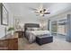 Cozy primary bedroom featuring a ceiling fan, accent lamps, and sliding glass door at 445 S Omaha --, Mesa, AZ 85206