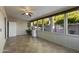Sun room with floor-to-ceiling windows offering views of lush landscaping at 445 S Omaha --, Mesa, AZ 85206