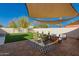 Backyard patio with shade awning, turf grass, and stylish outdoor furniture on top of a geometric outdoor rug at 4539 N 9Th Ave, Phoenix, AZ 85013
