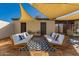 Cozy backyard patio area with stylish seating and shade awning, perfect for outdoor entertaining at 4539 N 9Th Ave, Phoenix, AZ 85013