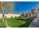 A spacious backyard featuring lush turf grass and a charming patio area with stylish outdoor furniture at 4539 N 9Th Ave, Phoenix, AZ 85013