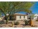 Charming single-story home with xeriscaping, vibrant tree, and a bright turquoise front door at 4539 N 9Th Ave, Phoenix, AZ 85013