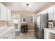 Open kitchen with stainless steel refrigerator, breakfast bar, and access to outdoor patio at 4539 N 9Th Ave, Phoenix, AZ 85013