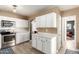 Bright kitchen showcasing stainless steel appliances, white cabinets and marble countertops at 4539 N 9Th Ave, Phoenix, AZ 85013