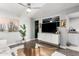 Open-concept living room featuring sleek media console, wood floors, and adjacent kitchen at 4539 N 9Th Ave, Phoenix, AZ 85013