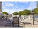 Inviting backyard with a brick patio, seating area, mature trees and desert landscaping at 5142 E Edgewood Cir, Mesa, AZ 85206