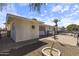 Beautiful backyard showcasing desert landscaping, a patio area, and mature trees at 5142 E Edgewood Cir, Mesa, AZ 85206