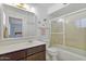 Bathroom with a vanity, enclosed shower/tub with a sliding door and plenty of light at 5142 E Edgewood Cir, Mesa, AZ 85206