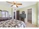 Comfortable bedroom featuring neutral green walls, a ceiling fan, and an attached closet at 5142 E Edgewood Cir, Mesa, AZ 85206