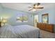 Comfortable bedroom with a large window, wooden dresser, and neutral decor for a relaxing space at 5142 E Edgewood Cir, Mesa, AZ 85206