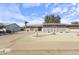 Charming single-story home featuring a well-manicured yard with desert landscaping and mature trees at 5142 E Edgewood Cir, Mesa, AZ 85206