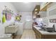 Bright laundry room boasts ample shelving, countertop space, and a washer and dryer at 5142 E Edgewood Cir, Mesa, AZ 85206