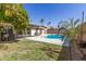 Inviting backyard showcasing a refreshing private pool, patio seating and mature trees at 519 W Palomino Dr, Chandler, AZ 85225