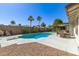 Picture of the private backyard pool complete with diving board, patio, and luscious greenery at 519 W Palomino Dr, Chandler, AZ 85225