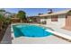 Private backyard pool with diving board surrounded by lush landscaping and patio seating at 519 W Palomino Dr, Chandler, AZ 85225