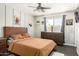 Cozy bedroom features a wood bed frame, dresser, modern ceiling fan and neutral decor with plenty of natural light at 519 W Palomino Dr, Chandler, AZ 85225