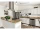 Bright kitchen featuring stainless steel appliances and a peninsula island with granite countertops at 519 W Palomino Dr, Chandler, AZ 85225