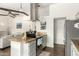 Modern kitchen boasts stainless steel appliances, granite countertops, open layout to the living room, and wood beam ceiling at 519 W Palomino Dr, Chandler, AZ 85225