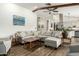 Spacious living room with a large sectional couch, ceiling fan, and wood-look tile floors at 519 W Palomino Dr, Chandler, AZ 85225