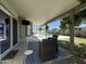 Relaxing covered patio features stylish seating, a TV, and views of the refreshing pool at 519 W Palomino Dr, Chandler, AZ 85225