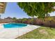 A backyard view of the private pool with water feature and mature trees and landscaping at 519 W Palomino Dr, Chandler, AZ 85225