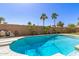 The pool is surrounded by mature palms and greenery, creating a private backyard oasis at 519 W Palomino Dr, Chandler, AZ 85225