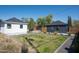Backyard with a mix of grass, gravel, desert plants, and two small buildings at 521 W Cambridge Ave, Phoenix, AZ 85003