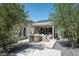 Serene backyard featuring a covered patio, lush greenery, and a charming stone pathway at 521 W Cambridge Ave, Phoenix, AZ 85003
