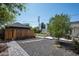 Tranquil backyard with gravel landscaping, a brick pathway, and views of the home's architecture at 521 W Cambridge Ave, Phoenix, AZ 85003