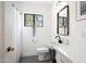 Stylish bathroom with a black-framed window, modern fixtures, and unique design elements at 521 W Cambridge Ave, Phoenix, AZ 85003