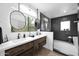 Modern bathroom with a double vanity, stylish mirrors, and a walk-in shower at 521 W Cambridge Ave, Phoenix, AZ 85003