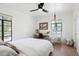 Bedroom with a workstation, a crib, a large window, and hardwood floors at 521 W Cambridge Ave, Phoenix, AZ 85003