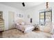Bright bedroom featuring a cozy bed, decorative artwork, and a relaxing hanging chair near the window at 521 W Cambridge Ave, Phoenix, AZ 85003