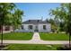 Charming home with a well-manicured lawn, neatly trimmed trees, and a welcoming walkway at 521 W Cambridge Ave, Phoenix, AZ 85003
